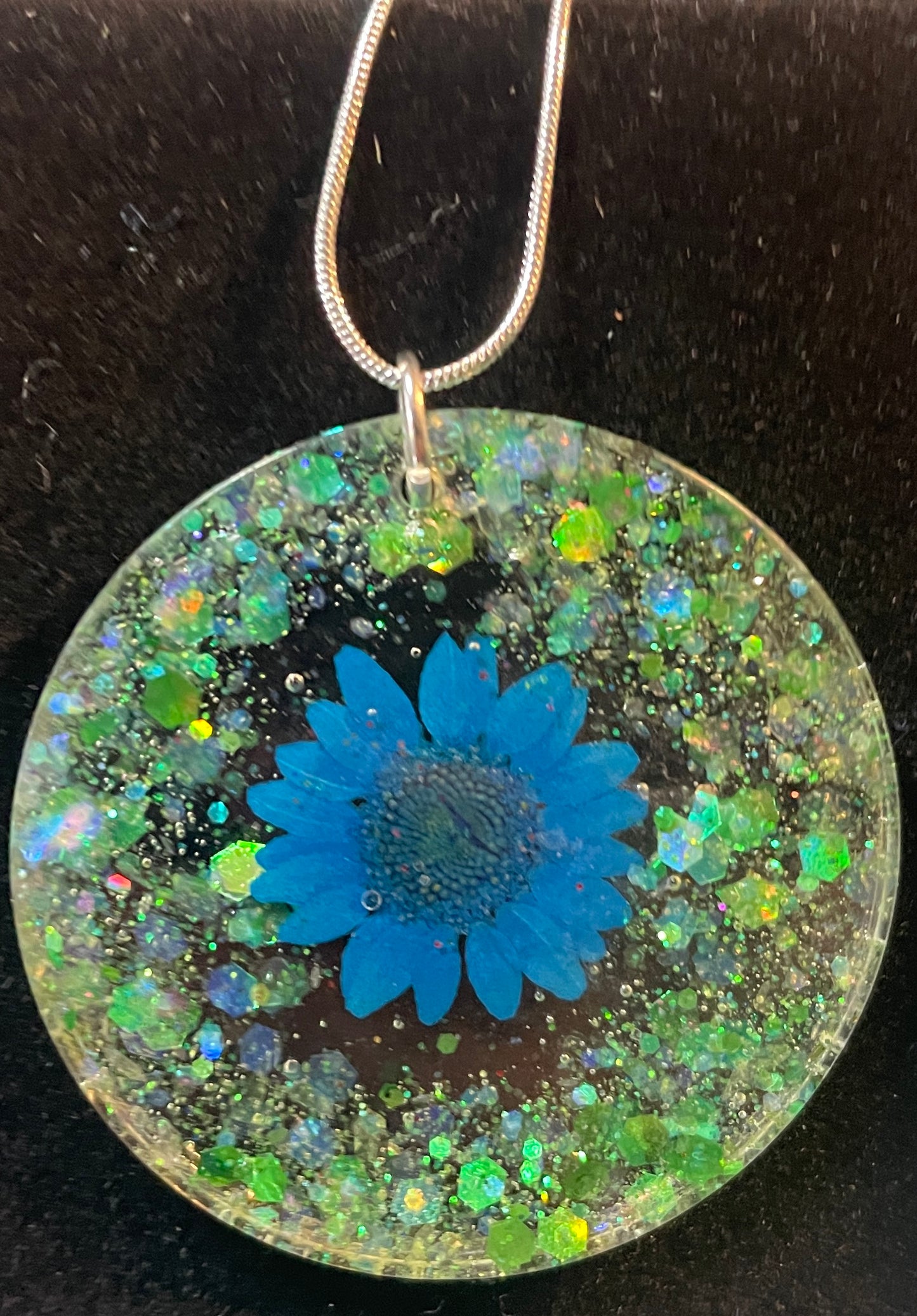 Circular Necklace with Blue Flower and Green Accent